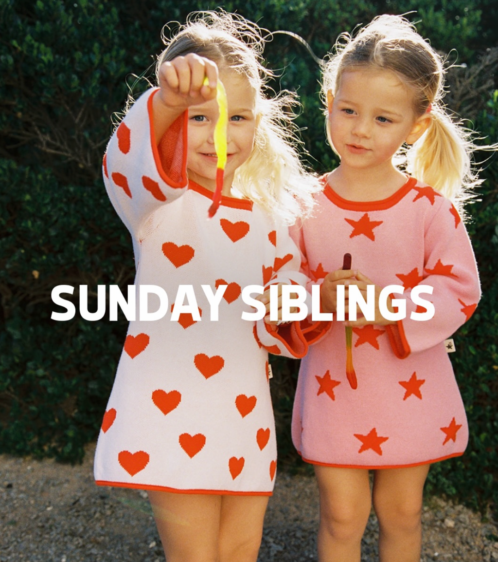 Lucky Stars Dress Pink + Red - two girls wearing Sunday Siblings knitwear outdoors